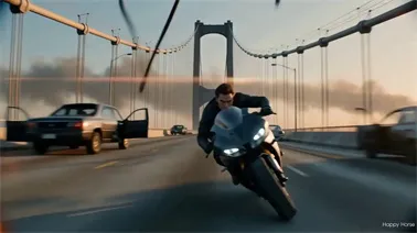 AI-generated action video of a motorcycle rider escaping a helicopter attack across a collapsing suspension bridge at sunset, made with HappyHorse 1.1.